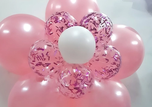 Flor rosada con centro blanco hecha de globos